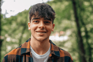 a teen smiles while participating in an Adolescent Aftercare Program