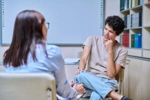 a teen talks to a counselor in a suicide prevention program