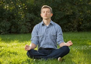 a boy practices meditation therapy
