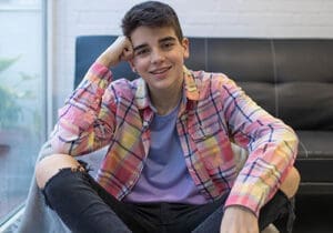 a teen boy smiles after motivational interviewing therapy