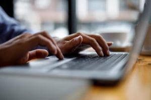 a person looks for referring professionals on a laptop