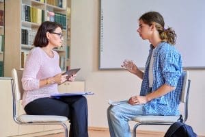 a teen talks to a therapist during adolescent EMDR therapy